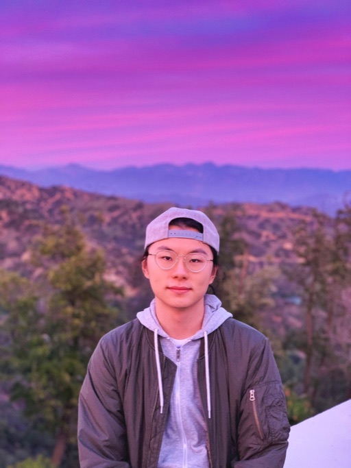 Yuxiang Gao in front of a violet dusk sky over the mountains